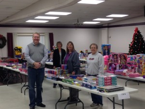 Member Doug Meyer and volunteers prepare to distribute toys.