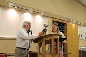 Exalted Ruler Dennis DeWild presents Jessica Hammers with a certificate and flag in recognition of her accomplishment.