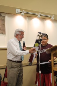 Exalted Ruler Dennis DeWild presents David Rendon with a certificate and flag in recognition of his accomplishment.